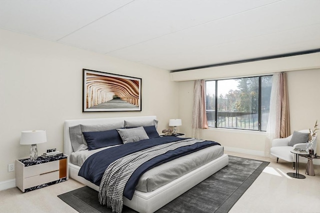 bedroom featuring carpet floors and baseboards