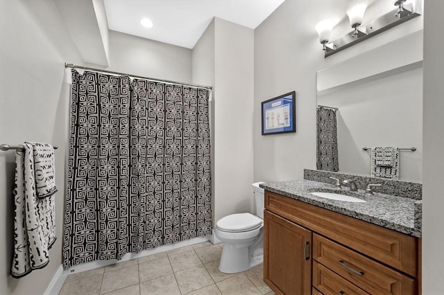 bathroom with tile patterned flooring, vanity, and toilet