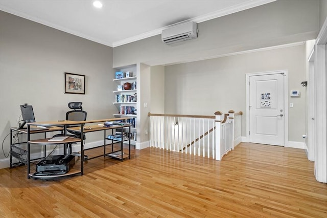 home office featuring light hardwood / wood-style floors, built in features, crown molding, and a wall mounted AC