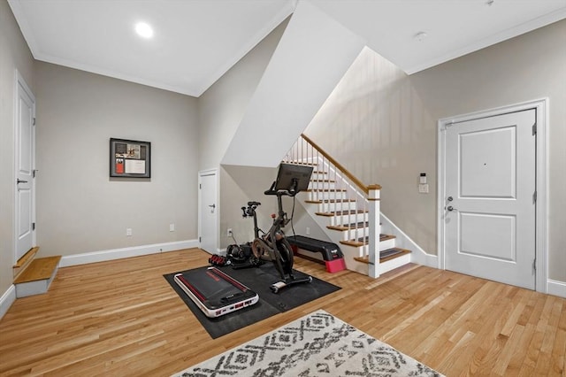 workout area featuring hardwood / wood-style floors and ornamental molding