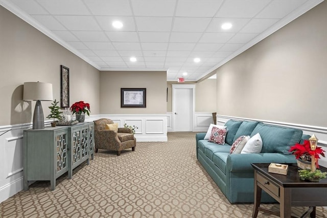 carpeted living room with ornamental molding