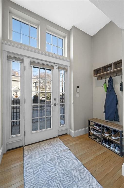 interior space with light hardwood / wood-style floors and a high ceiling