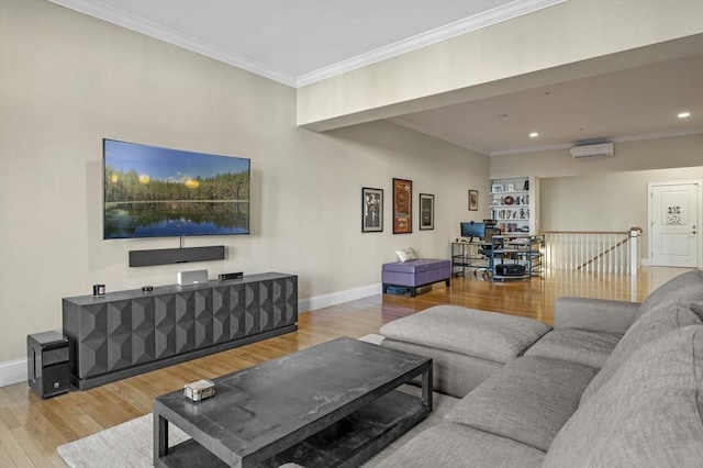 living room with an AC wall unit, built in shelves, crown molding, and hardwood / wood-style floors