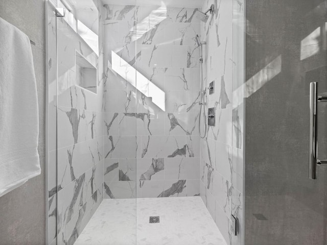 full bathroom featuring a marble finish shower