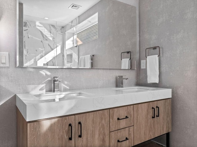 full bathroom featuring double vanity, tasteful backsplash, visible vents, and a sink