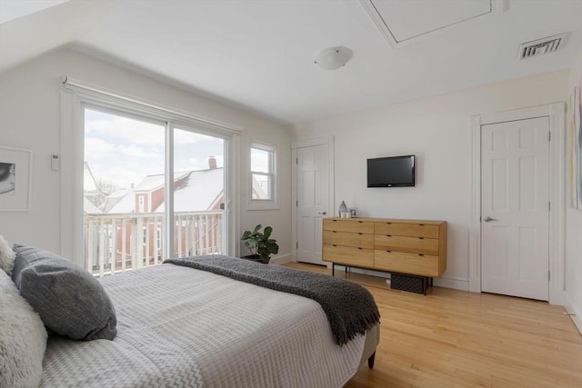 bedroom with visible vents, baseboards, access to exterior, vaulted ceiling, and light wood-style floors