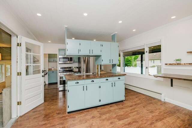 9 Mount Hope St, North Attleboro, MA 02760 - kitchen with appliances with stainless steel finishes, a baseboard heating unit, butcher block countertops, blue cabinets, and ornamental molding