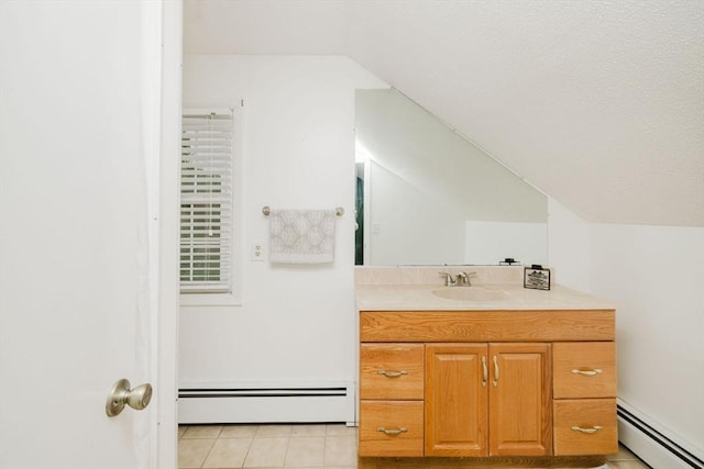 9 Mount Hope St, North Attleboro, MA 02760 - bathroom featuring baseboard heating, vaulted ceiling, vanity, and tile patterned flooring