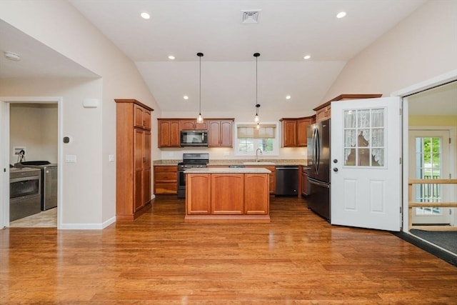 9 Mount Hope St, North Attleboro, MA 02760 - kitchen with stainless steel appliances, vaulted ceiling, a sink, light wood-style flooring, and a kitchen island