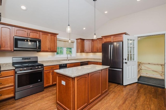 9 Mount Hope St, North Attleboro, MA 02760 - kitchen with stainless steel appliances, dark wood finished floors, lofted ceiling, light stone counters, and pendant lighting