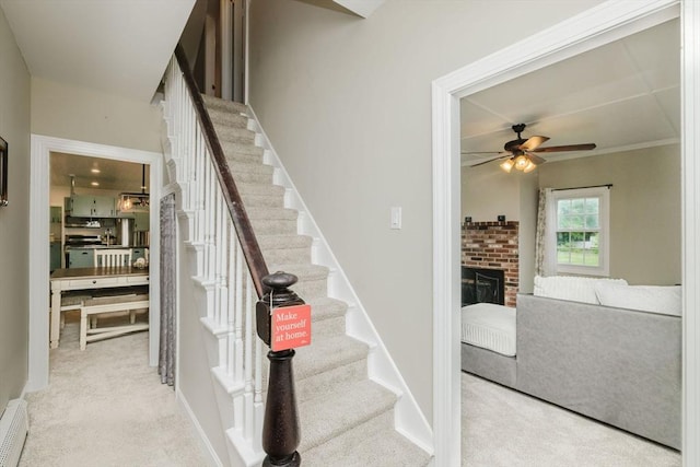 9 Mount Hope St, North Attleboro, MA 02760 - stairway with a ceiling fan, carpet flooring, and a fireplace