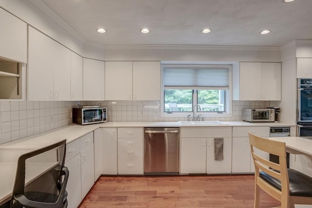 kitchen featuring sink, light hardwood / wood-style floors, white cabinets, and appliances with stainless steel finishes