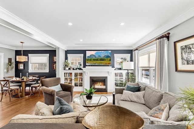 living room with crown molding and light wood-type flooring