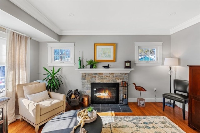 sitting room with crown molding, plenty of natural light, and hardwood / wood-style floors