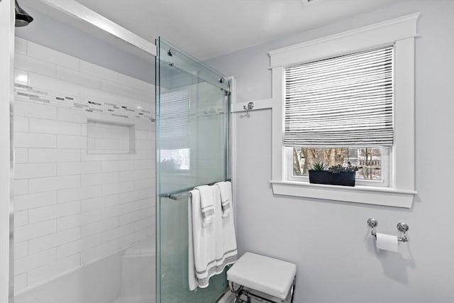 bathroom featuring an enclosed shower and a healthy amount of sunlight