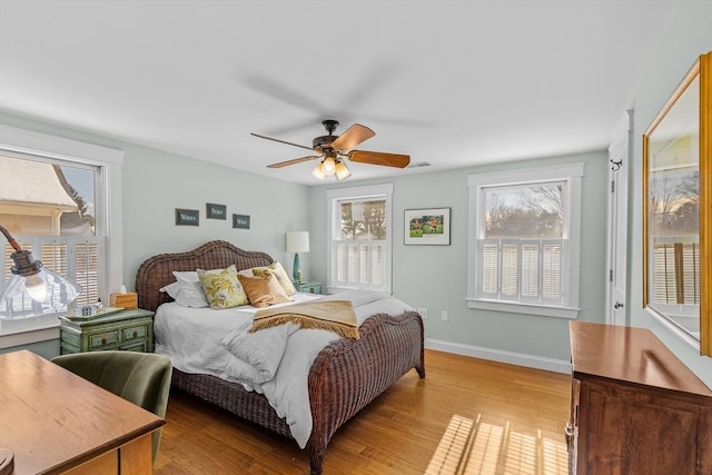 bedroom with ceiling fan, access to exterior, and light hardwood / wood-style floors