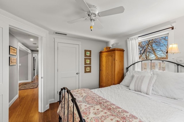 bedroom with wood-type flooring, a closet, and ceiling fan