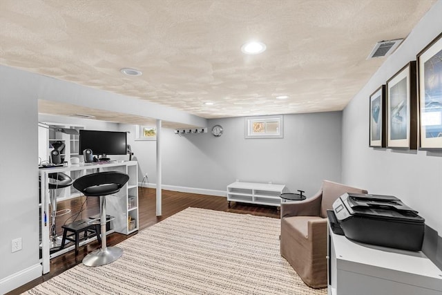 office space with hardwood / wood-style flooring and a textured ceiling