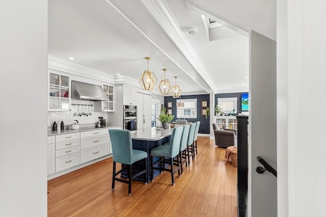 dining area with crown molding and light hardwood / wood-style floors