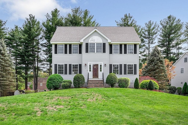 colonial-style house with a front lawn