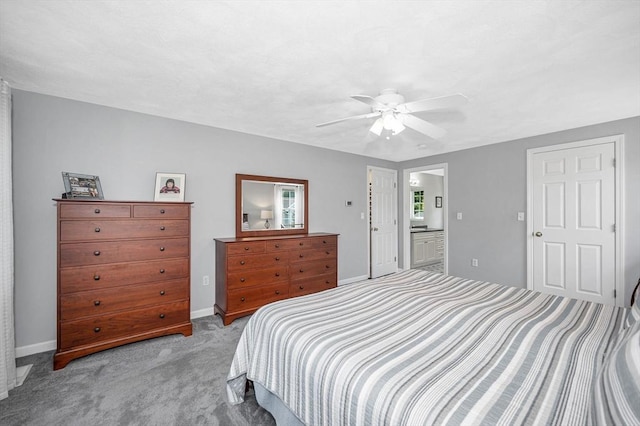 bedroom with carpet floors, ensuite bathroom, ceiling fan, and baseboards