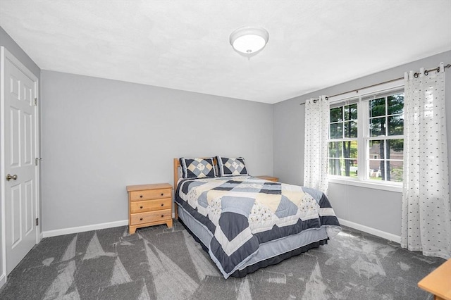 bedroom featuring carpet flooring and baseboards