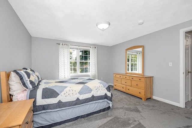 carpeted bedroom featuring baseboards