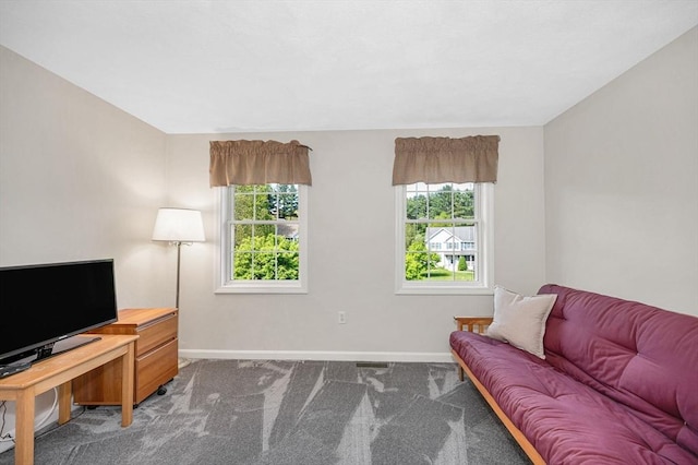 carpeted living room featuring baseboards