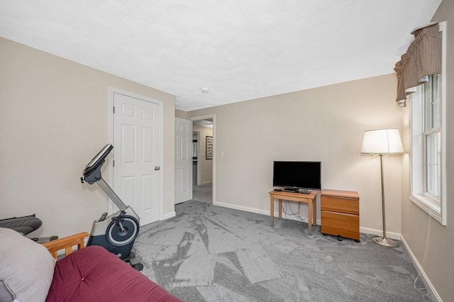 carpeted living room featuring baseboards