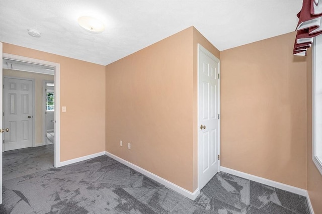 empty room with carpet floors and baseboards