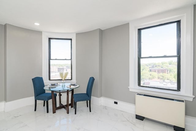 140 Chestnut St Unit 606, Springfield, MA 01103 - dining room featuring radiator, baseboards, light marble finish floors, and recessed lighting