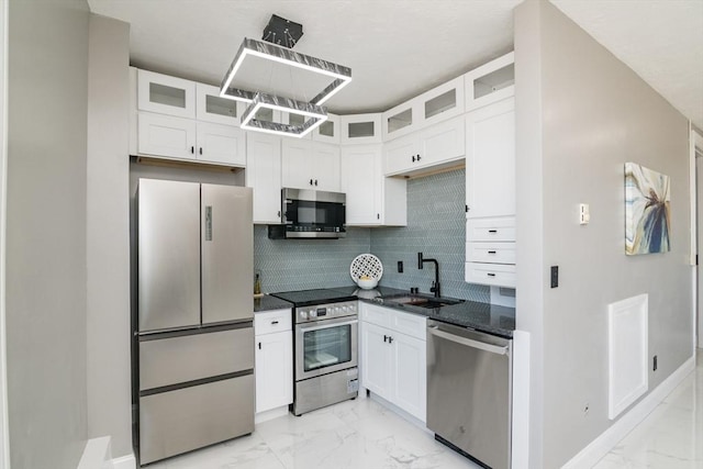 140 Chestnut St Unit 606, Springfield, MA 01103 - kitchen featuring appliances with stainless steel finishes, a sink, light marble finish flooring, white cabinets, and backsplash
