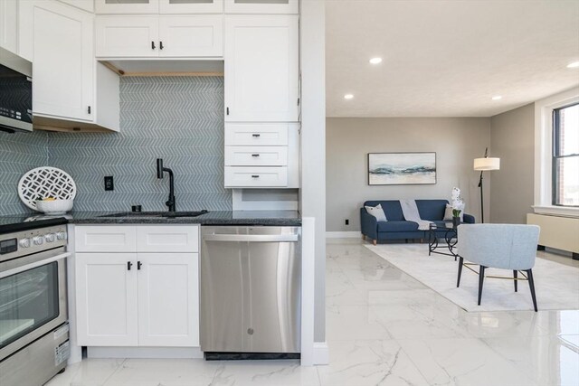 140 Chestnut St Unit 606, Springfield, MA 01103 - kitchen with appliances with stainless steel finishes, light marble finish floors, a sink, recessed lighting, and decorative backsplash