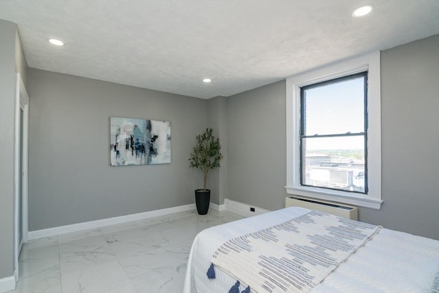 140 Chestnut St Unit 606, Springfield, MA 01103 - bedroom with light marble finish floors, recessed lighting, baseboards, and a wall mounted AC