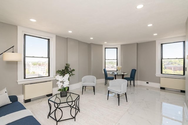 140 Chestnut St Unit 606, Springfield, MA 01103 - living area featuring radiator heating unit, recessed lighting, light marble finish floors, and baseboards