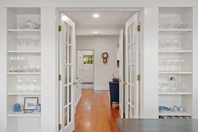 196 Elm St, Concord, MA 01742 - corridor featuring french doors and light wood-style floors