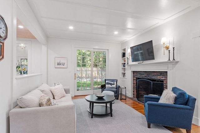196 Elm St, Concord, MA 01742 - living room with wood finished floors, a fireplace, built in shelves, and recessed lighting