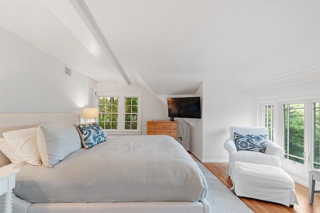 196 Elm St, Concord, MA 01742 - bedroom featuring multiple windows, wood finished floors, and lofted ceiling