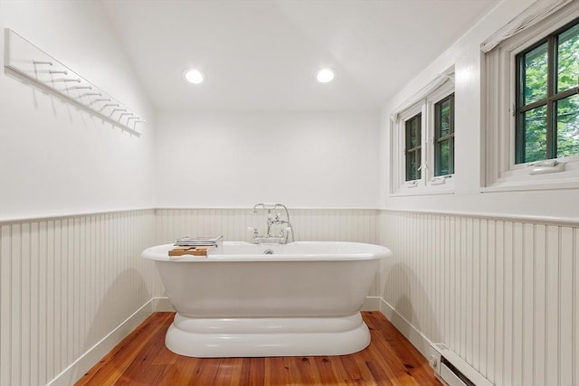 196 Elm St, Concord, MA 01742 - full bathroom with wood finished floors, wainscoting, a soaking tub, and a baseboard radiator