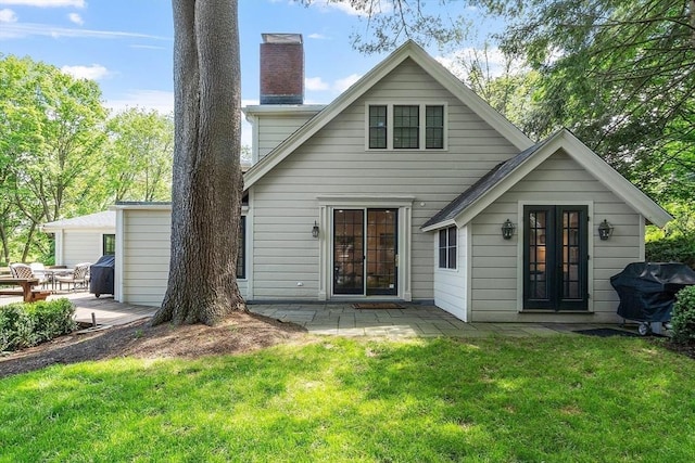 196 Elm St, Concord, MA 01742 - back of property with a patio, a yard, and a chimney