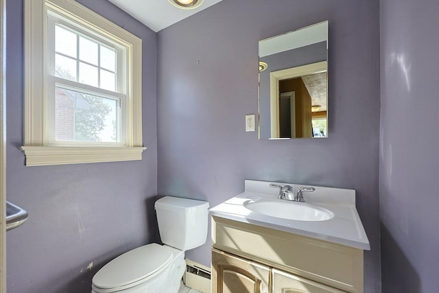 bathroom with a baseboard heating unit, toilet, and vanity