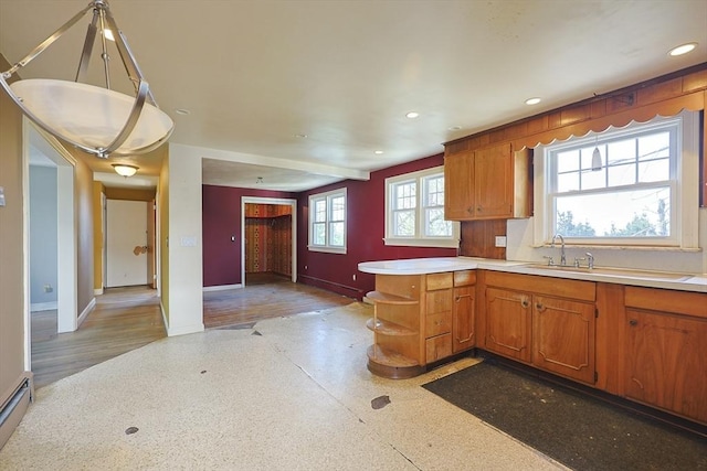 kitchen with baseboards, light countertops, open shelves, brown cabinets, and recessed lighting