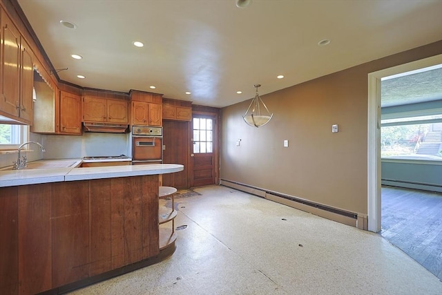 kitchen featuring wall oven, a sink, under cabinet range hood, healthy amount of natural light, and recessed lighting