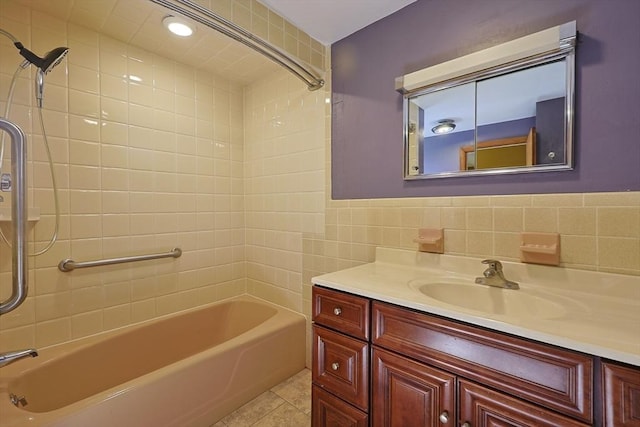 bathroom featuring tile walls, washtub / shower combination, vanity, and tile patterned flooring