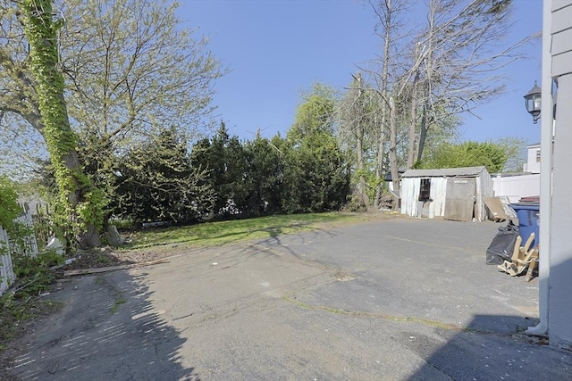 view of patio with a storage shed and an outdoor structure