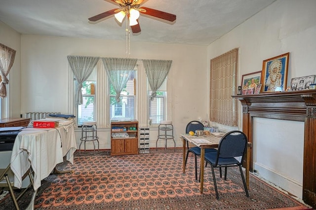 carpeted dining room featuring ceiling fan