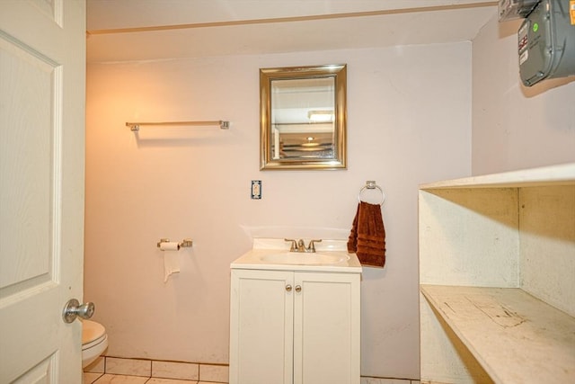 bathroom featuring tile patterned flooring, vanity, and toilet