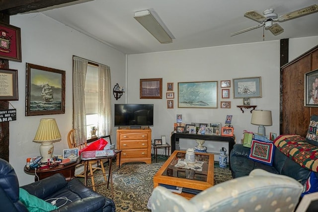 living room with beamed ceiling and ceiling fan