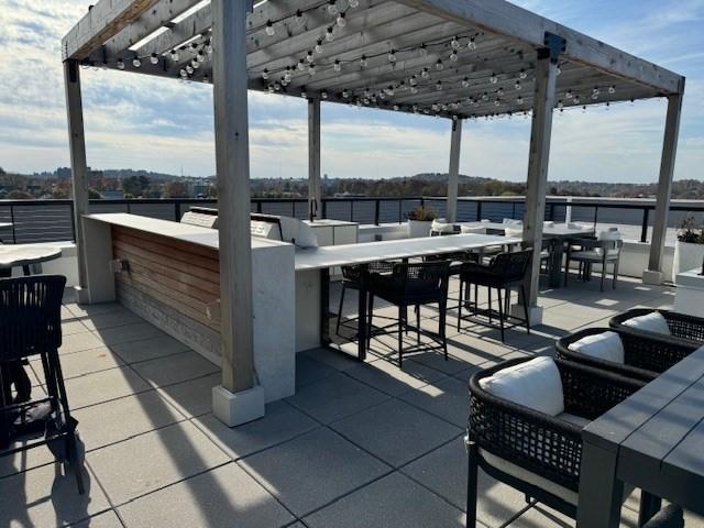 view of patio / terrace with a pergola and outdoor dry bar