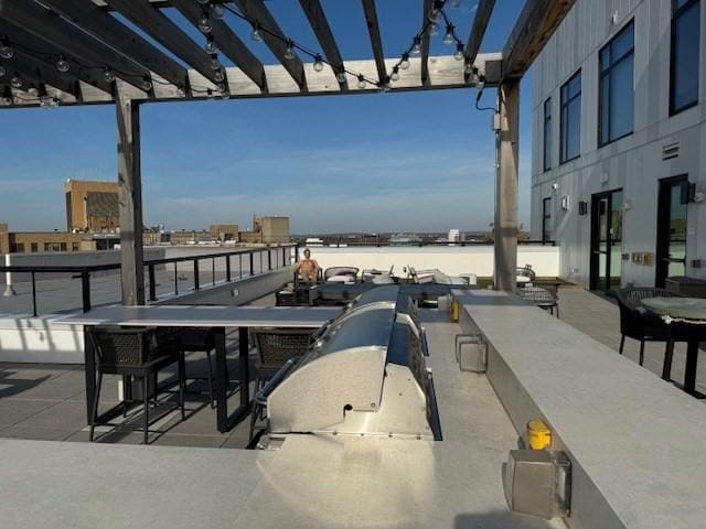 view of patio / terrace featuring outdoor dining space, a water view, and a pergola